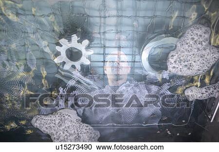 Stock Image - Worker cleaning with ultrasonics. Fotosearch