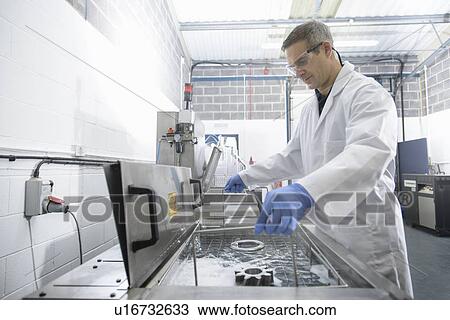 Worker cleaning with ultrasonics View Large Photo Image Stock Image - Worker cleaning with ultrasonics. Fotosearch