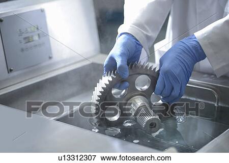 Stock Photo - Worker cleaning with ultrasonics. Fotosearch