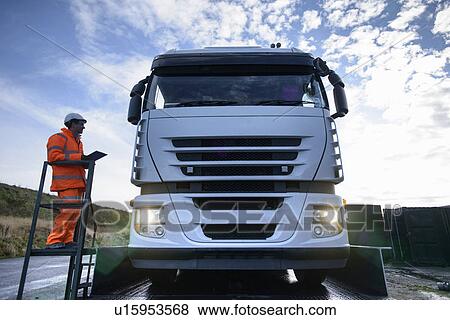 Worker directing truck on scales View Large Photo Image Stock Photo - Worker directing truck on scales. Fotosearch