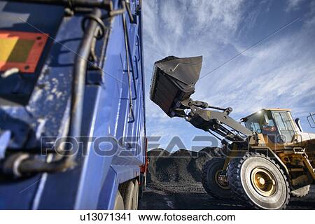Worker driving excavator at coal mine View Large Photo Image Stock Image - Worker driving excavator at coal mine. Fotosearch