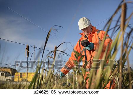 Worker monitoring water at coal mine View Large Photo Image Stock Photograph - Worker monitoring water at coal mine. Fotosearch