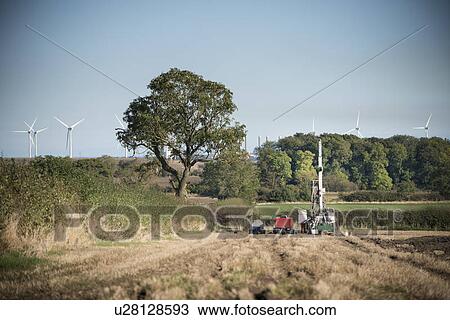 Stock Image - Worker on drilling rig at coal mine. Fotosearch