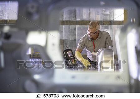 Worker testing welding in car plant View Large Photo Image Stock Image - Worker testing welding in car plant. Fotosearch