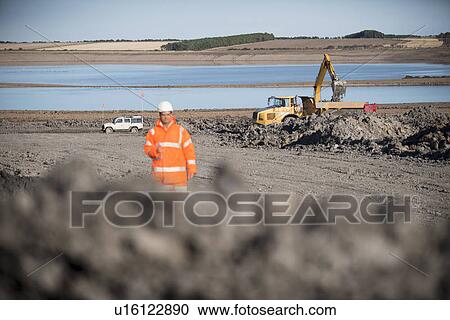Worker walking on surface coal mine View Large Photo Image Stock Image - Worker walking on surface coal mine. Fotosearch