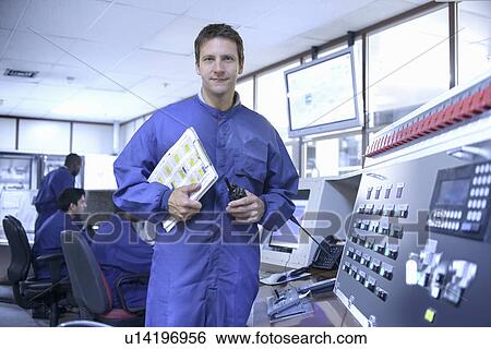 Worker with walkie talkie in car factory View Large Photo Image Stock Photograph - Worker with walkie talkie in car factory. Fotosearch