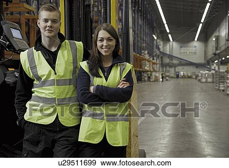 Stock Photo - Workers by forklift in warehouse. Fotosearch