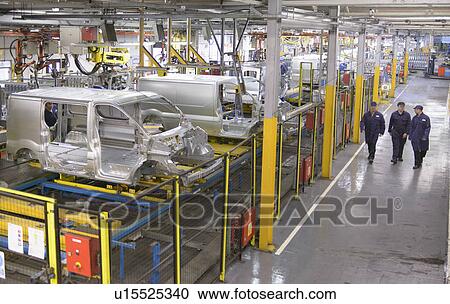 Stock Image - Workers walking in car factory. Fotosearch