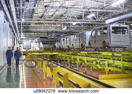 Workers walking in car factory View Large Photo Image Stock Photograph - Workers walking in car factory. Fotosearch