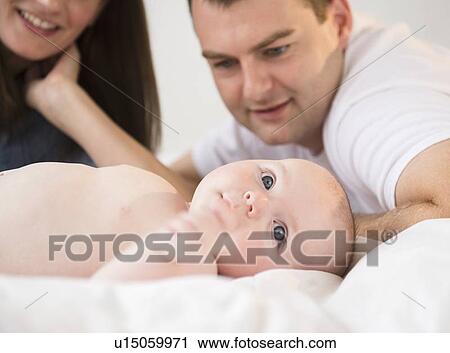 Baby boy (2-5 months) and parents View Large Photo Image Stock Image - Baby boy (2-5 months) and parents. Fotosearch