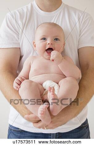 Baby boy (2-5 months) held by father View Large Photo Image Stock Image - Baby boy (2-5 months) held by father. Fotosearch