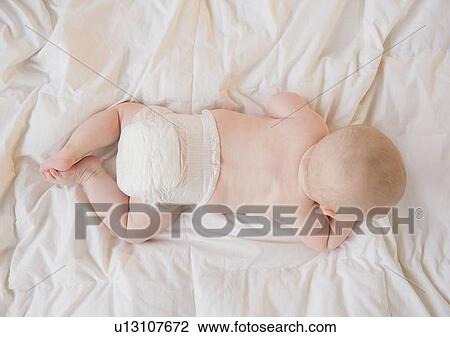 Baby boy (2-5 months) lying on front View Large Photo Image Stock Image - Baby boy (2-5 months) lying on front. Fotosearch
