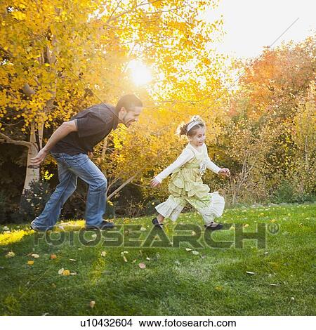 Picture - Bountiful, Family with two daughters (2-3, 4-5) playing in garden . Fotosearch