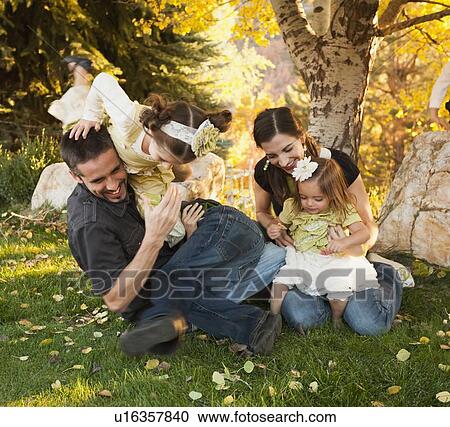 Bountiful, Family with two daughters (2-3, 4-5) playing in garden View Large Photo Image Stock Image - Bountiful, Family with two daughters (2-3, 4-5) playing in garden . Fotosearch