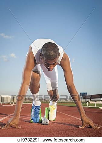 Boy (12-13) preparing for running on starting line View Large Photo Image Stock Image - Boy (12-13) preparing for running on starting line. Fotosearch