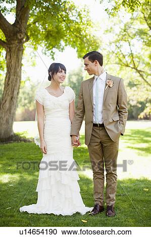 Bride and groom strolling in park View Large Photo Image Stock Image - Bride and groom strolling in park. Fotosearch