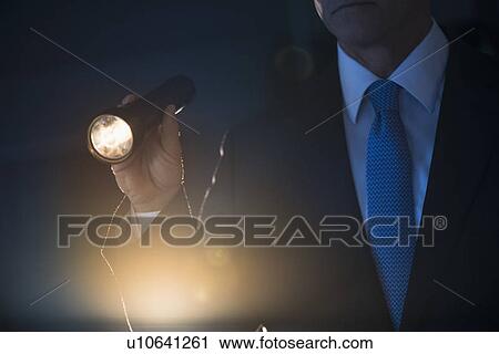 Businessman holding flashlight View Large Photo Image Stock Image - Businessman holding flashlight. Fotosearch
