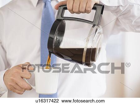 Stock Image - Businessman pouring coffee. Fotosearch