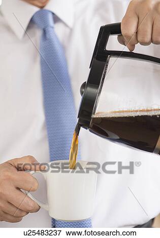Stock Photo - Businessman pouring coffee. Fotosearch