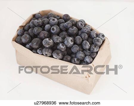 Stock Photograph - Carton of blueberries on white background. Fotosearch