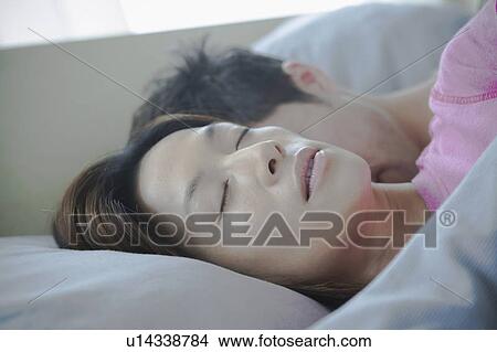 Picture - Close up of couple sleeping. Fotosearch