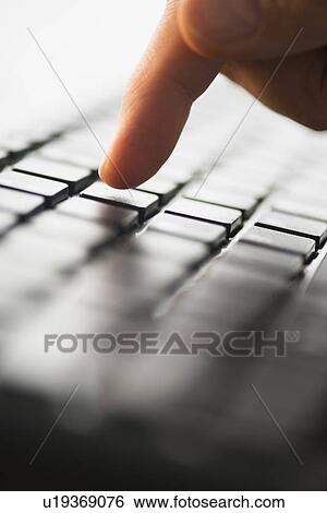 Close-up of finger typing on keyboard View Large Photo Image Stock Photograph - Close-up of finger typing on keyboard. Fotosearch