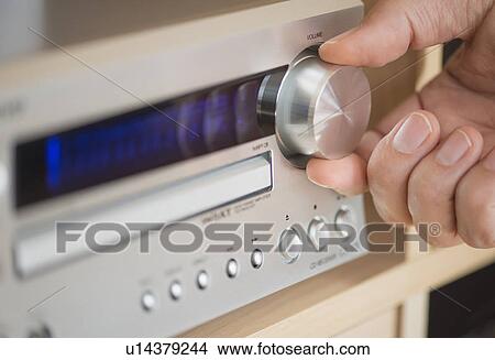 Picture - Close-up of hand adjusting audio system. Fotosearch
