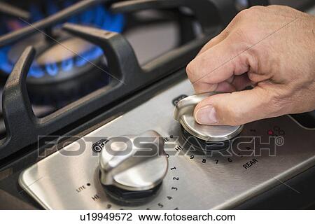 Close-up of hand adjusting stove burner View Large Photo Image Stock Image - Close-up of hand adjusting stove burner. Fotosearch