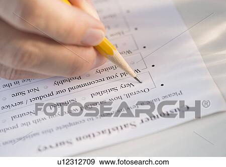 Close-up of hand filling out form View Large Photo Image Stock Photo - Close-up of hand filling out form. Fotosearch