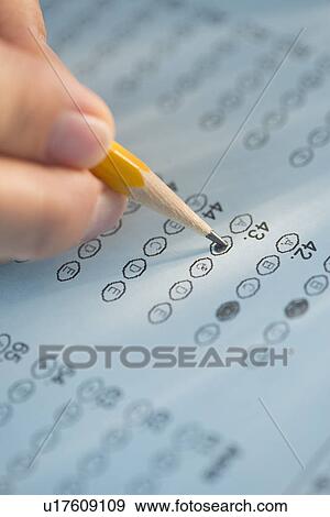 Close-up of hand filling out test View Large Photo Image Stock Photo - Close-up of hand filling out test. Fotosearch