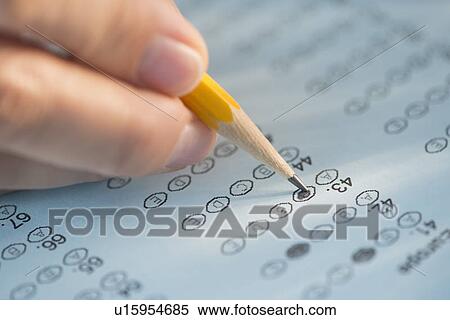 Close-up of hand filling out test View Large Photo Image Stock Photography - Close-up of hand filling out test. Fotosearch