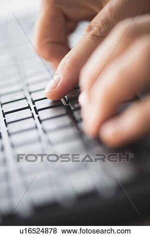 Stock Photo - Close-up of hands typing on keyboard. Fotosearch