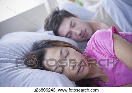 Stock Image - Close up of sleeping couple. Fotosearch