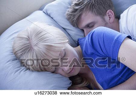 Stock Photo - Close up of sleeping couple. Fotosearch