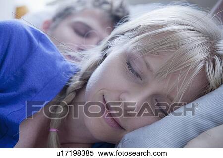 Stock Photography - Close up of sleeping couple. Fotosearch