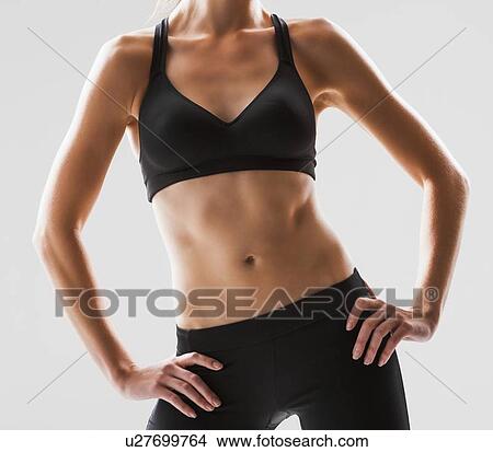 Close up of young woman exercising, studio shot View Large Photo Image Picture - Close up of young woman exercising, studio shot. Fotosearch