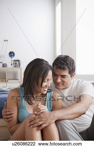 Couple cuddling at home View Large Photo Image Stock Image - Couple cuddling at home. Fotosearch