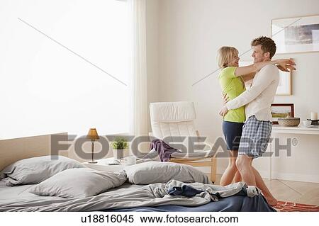 Stock Photography - Couple dancing in bedroom. Fotosearch