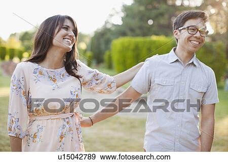 Stock Photo - Couple hanging out in park. Fotosearch