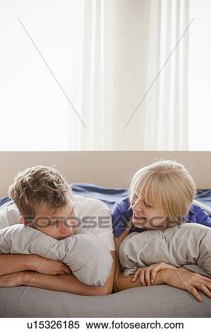 Stock Photography - Couple lying in bed. Fotosearch