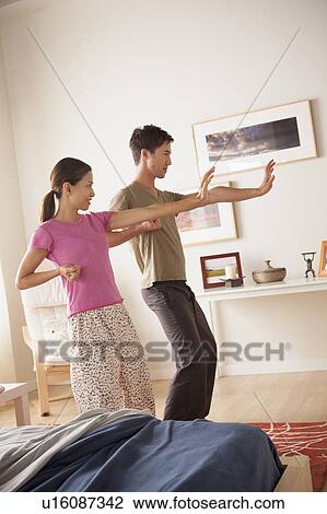Stock Image - Couple practicing tai chi. Fotosearch