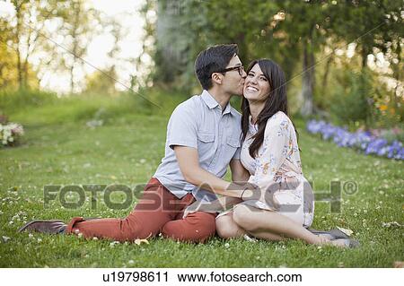 Couple relaxing in park View Large Photo Image Stock Image - Couple relaxing in park. Fotosearch