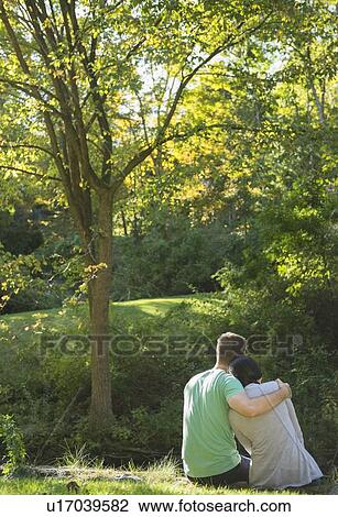 Couple sitting in park View Large Photo Image Stock Image - Couple sitting in park. Fotosearch