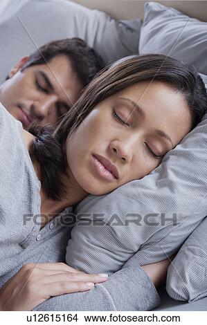 Couple sleeping in bed View Large Photo Image Picture - Couple sleeping in bed. Fotosearch