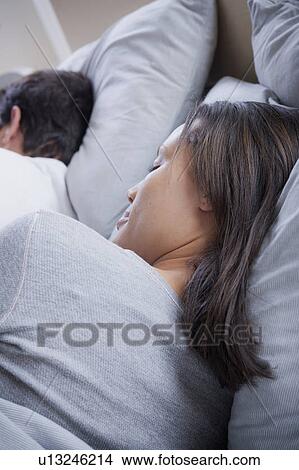 Couple sleeping in bed View Large Photo Image Picture - Couple sleeping in bed. Fotosearch