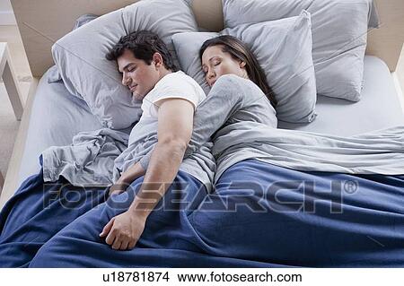 Couple sleeping in bed View Large Photo Image Picture - Couple sleeping in bed. Fotosearch