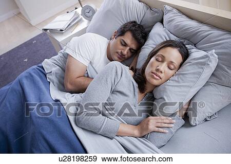 Couple sleeping in bed View Large Photo Image Stock Photo - Couple sleeping in bed. Fotosearch