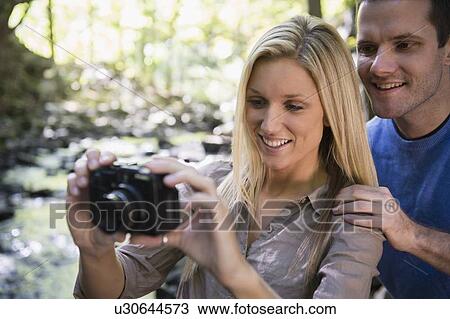 Couple taking picture in forest View Large Photo Image Stock Image - Couple taking picture in forest. Fotosearch