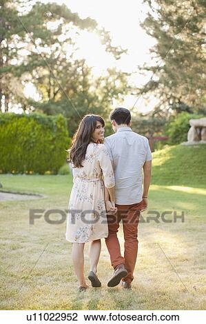 Couple walking in park View Large Photo Image Stock Image - Couple walking in park. Fotosearch