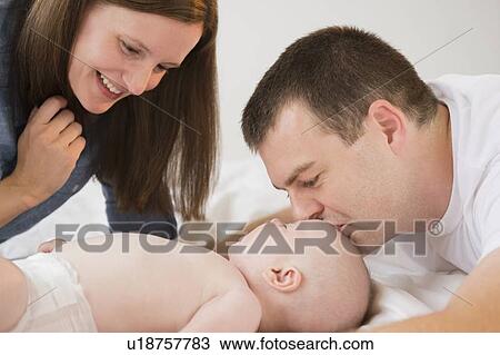 Stock Image - Family with baby boy (2-5 months). Fotosearch
